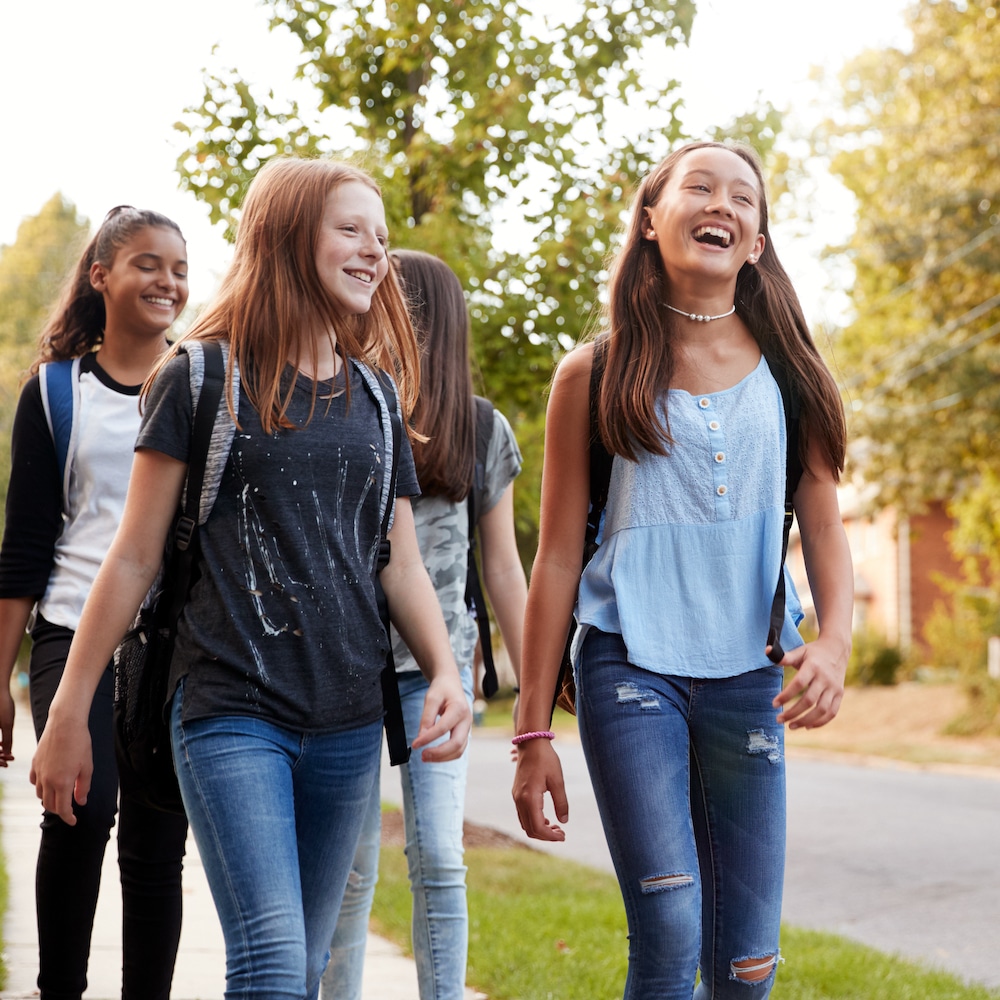 Four,Young,Teen,Girls,Walking,To,School,,Front,View,Close Four,Young,Teen,Girls,Walking,To,School,,Front,View,Close